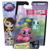 A set of three small plastic animal figures, including a pink hedgehog and a blue creature, packaged in a clear plastic displ