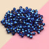 A pile of dark blue iridescent crystal glass beads for jewelry making