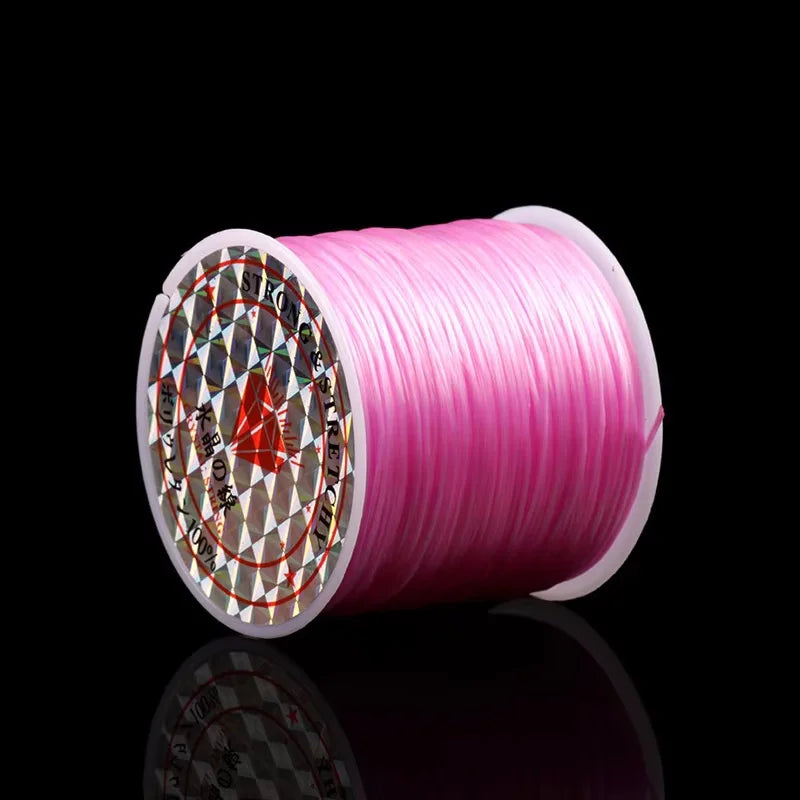 A roll of pink elastic beading cord for stretch bracelets and necklaces