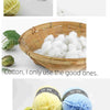 Yellow and blue soft milk cotton yarn balls and a wooden clothespin with yarn.