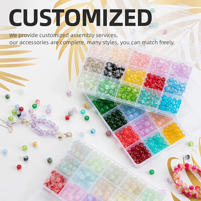 A variety of colorful smooth round glass beads in various shades are displayed in small plastic containers for jewelry making