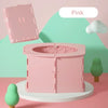 A pink foldable baby potty training seat is displayed on a white stand against a light green background.