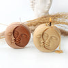 Two silicone molds shaped like serene faces for candles or soap making resting on straw