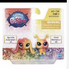A set of three small, colorful animal figures from a pet shop product packaging.