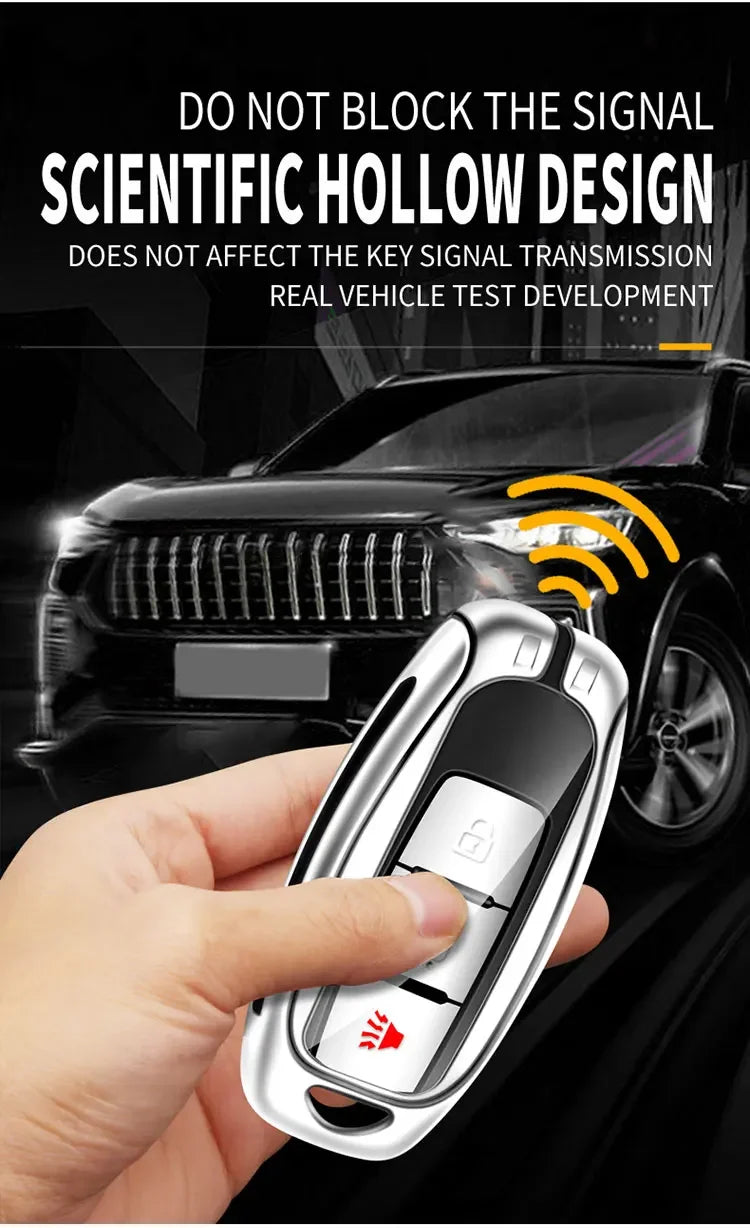 A hand holds a silver key case cover designed for Infiniti models, demonstrating a scientific hollow design.