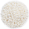 A pile of small, round ivory pearl beads for DIY jewelry making.