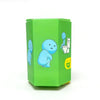 A green cardboard box for a glow-in-the-dark collectible featuring blue figures, including a toilet and a figure labeled Toy.