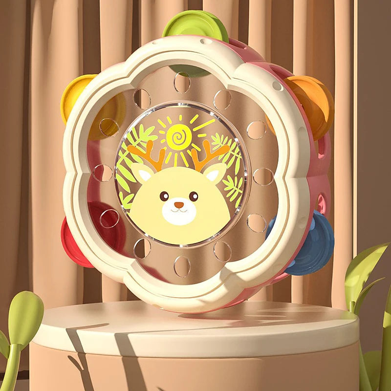 A pink and yellow baby musical instrument set featuring a hand drum and shake rattle for toddlers.
