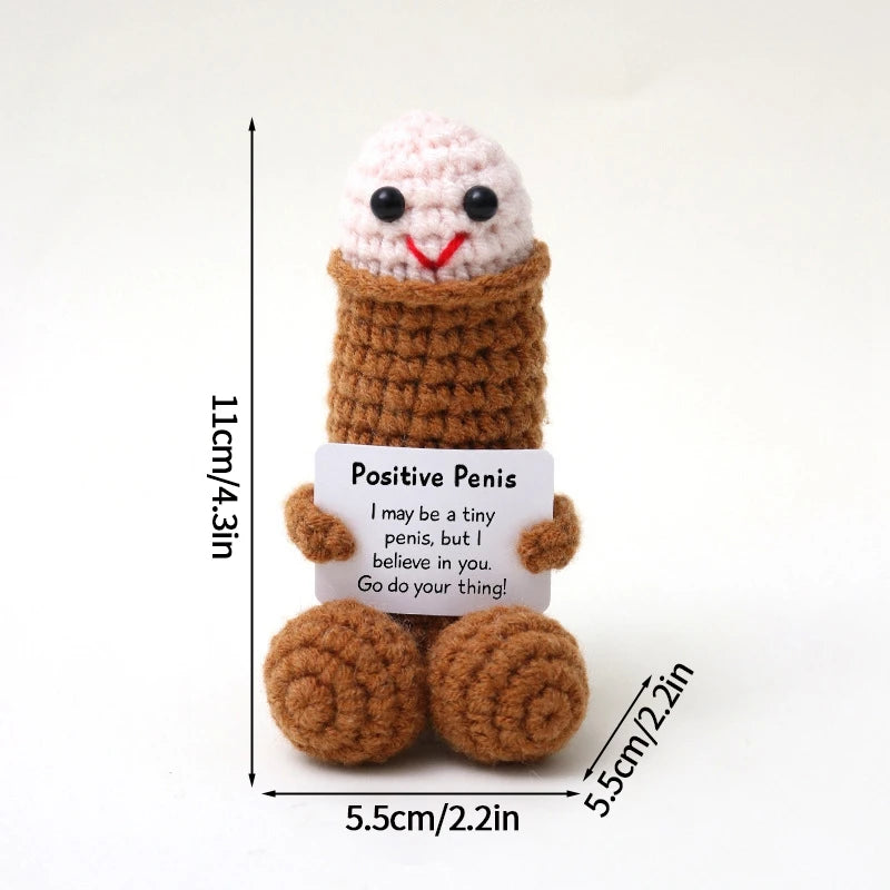 A handmade crochet pocket hug doll featuring a pink and white textured head and brown body with an inspirational message.