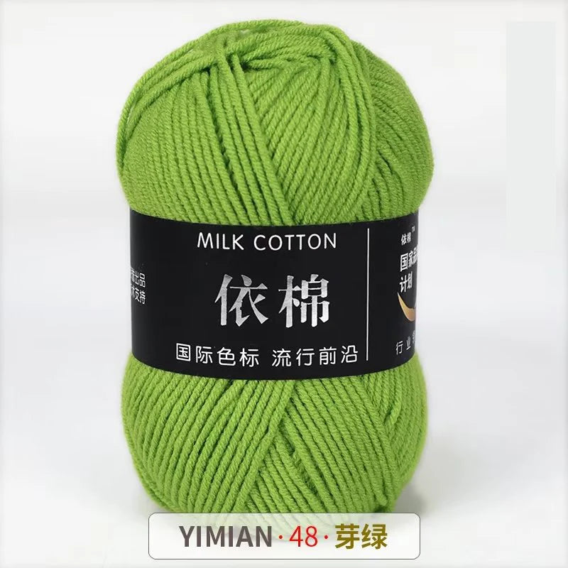 A ball of light green milk cotton yarn labeled YIMIAN 48 and featuring Chinese characters for knitting and crochet.