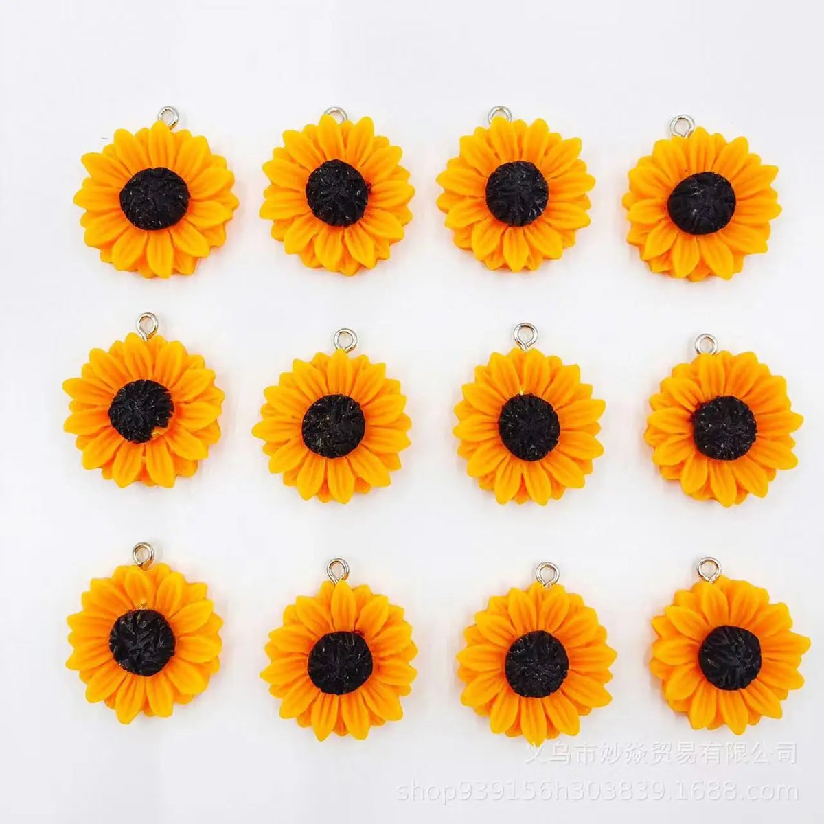 A set of bright orange and black sunflower charms for jewelry making.