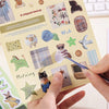 A page from a sticker book featuring various retro aesthetic stickers like a chipped teacup, wish, and morning themes.