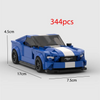 A blue and white classic supercar model built from building blocks, shown in a side profile.