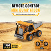 An orange mini dump truck RC vehicle is shown on a sandy terrain with its remote control transmitter.