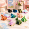 A set of eight colorful flexible salamander figurines in various shades of pink, green, blue, and orange arranged on a white 