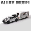 A white diecast model of an RV camper truck with a black roof and wheels.