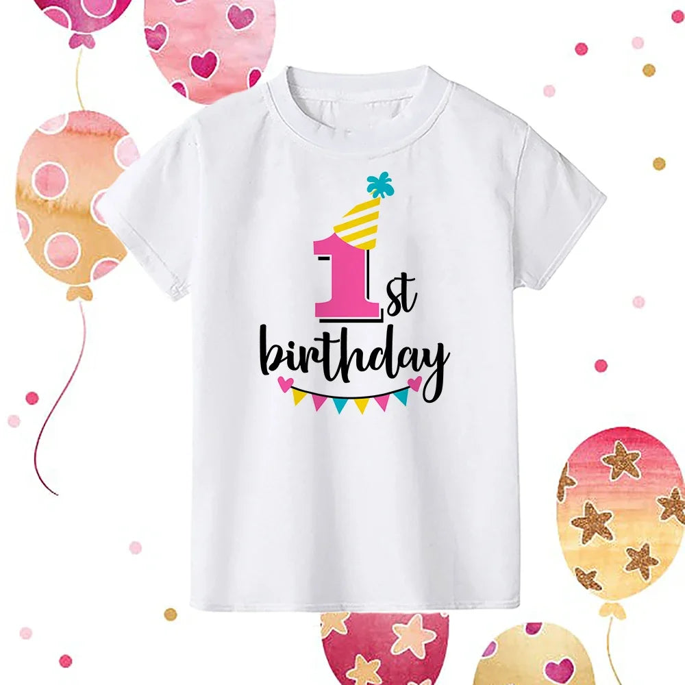 A white kids birthday number t-shirt featuring a pink and yellow first birthday design surrounded by colorful balloons.