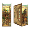A DIY book nook kit featuring a detailed miniature scene with traditional architecture and LED lighting.