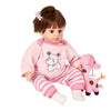 A baby doll wearing a pink animal romper set with stripes and white socks.