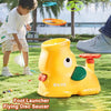 A yellow foot launcher toy is shown outdoors with a child playing nearby.