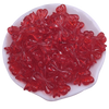A pile of 20 red acrylic bow beads for jewelry making displayed in a white dish.