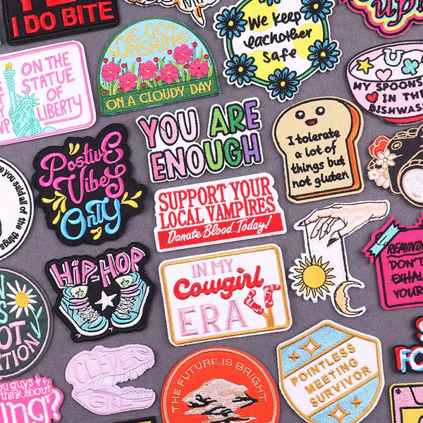 A collection of colorful DIY embroidery iron-on patches featuring text and designs for customization.