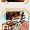 A miniature wooden dollhouse kit featuring furniture and architectural elements.