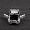 A silver 1/36 scale die-cast sports car with pull-back action displayed on a dark surface.