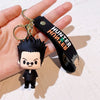 A black and white resin keychain of a Hunter x Hunter anime character with spiky hair and a dark outfit.