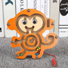 An orange wooden geometry puzzle featuring a stylized animal face and colored beads.