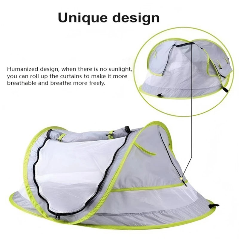 A gray and lime green instant pop-up baby tent with a mesh canopy shown open.