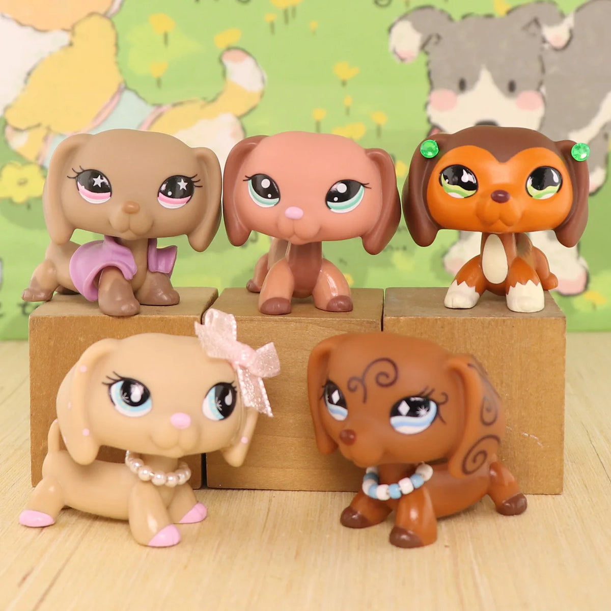 A set of dachshund bobblehead figurines in various shades of brown and tan against a green background.
