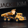 A yellow 1:87 scale articulated dumper truck diecast model with a raised bed.
