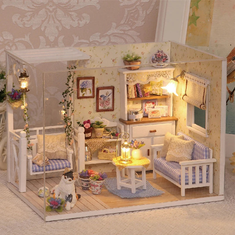 A detailed miniature dollhouse kit featuring white furniture, a cozy interior, and decorative elements for play.