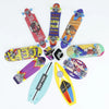 A collection of various finger surfboards and skateboards in bright colors including pink, purple, yellow, and blue.
