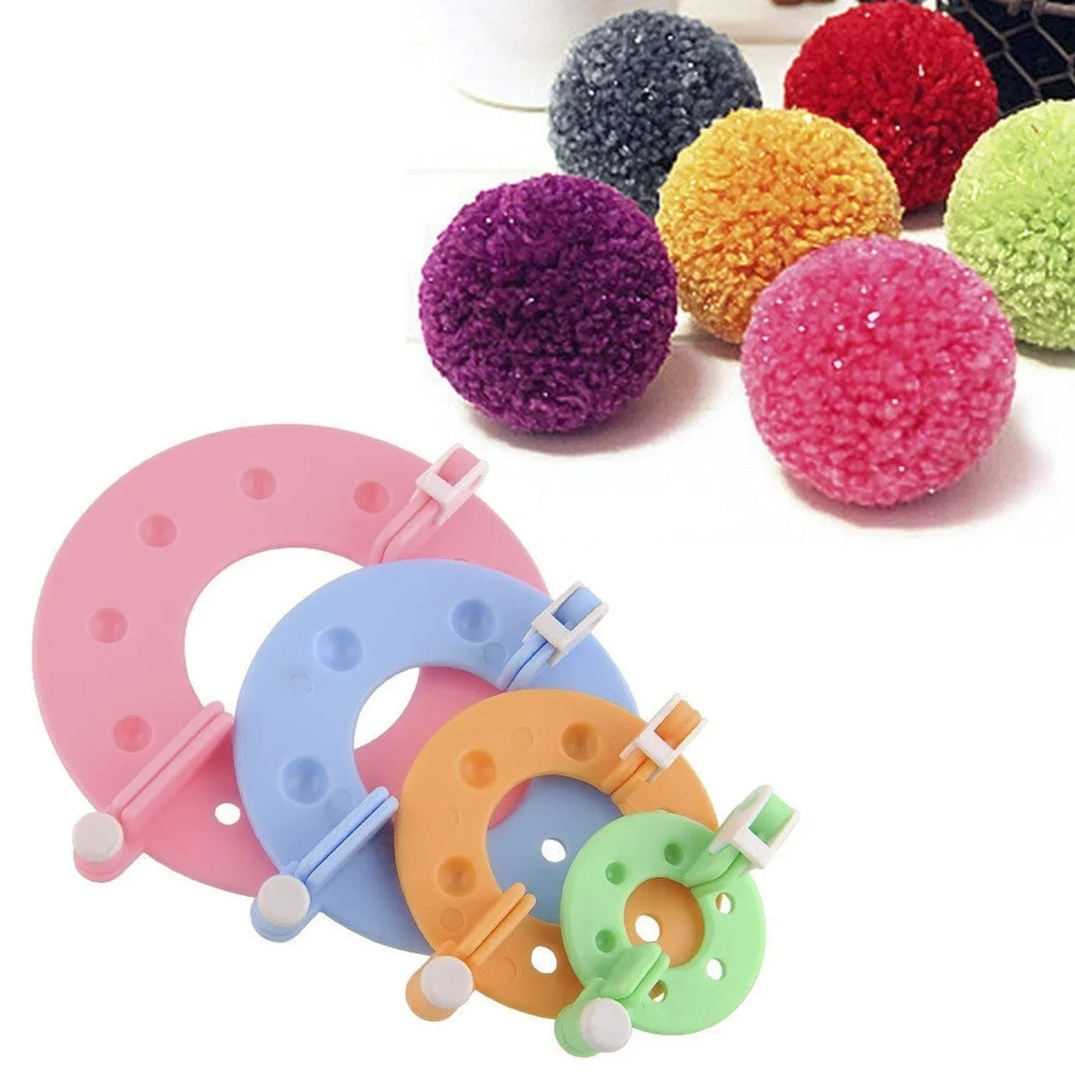 An assortment of colorful pom-pom making tools including various sized and colored pom-poms and knitting needles