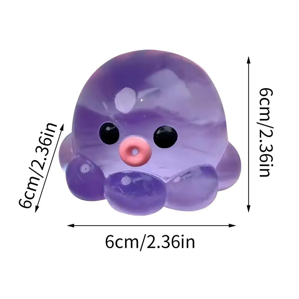 A translucent purple octopus squishy stress ball with black eyes and a pink nose.