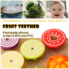 A set of silicone fruit and vegetable shaped baby teethers in red, yellow, and orange colors.