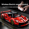 A red MOC hypercar building block model is shown with a hand holding a wireless electric remote control.