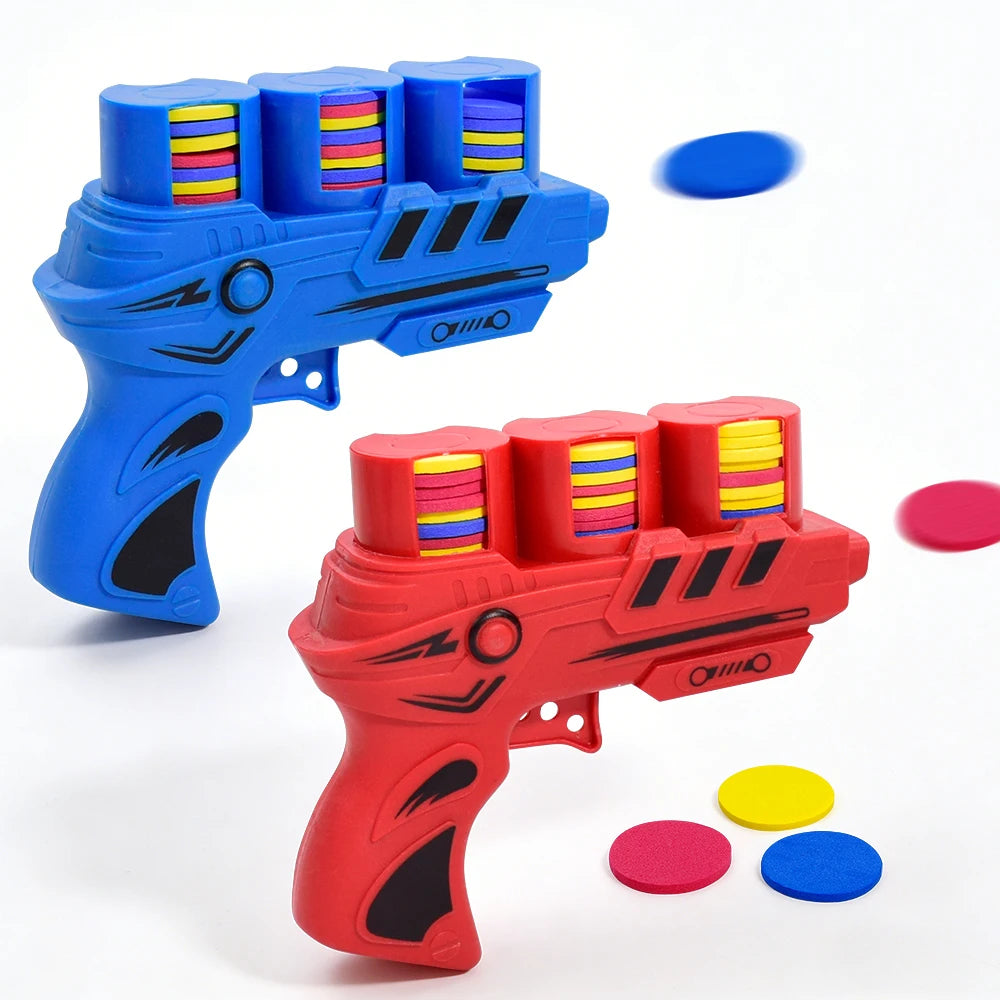 A red soft foam flying disc launcher toy with blue and yellow colored discs scattered nearby.