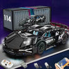 A black 1:14 scale RC sports car building kit is shown next to its packaging and various components.