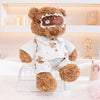 A brown teddy bear plush toy wearing a white shirt and pants with an eye mask that says Good Night