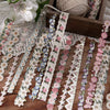 A collection of fabric-textured sticker strips in various floral patterns and colors for journaling and scrapbooking.