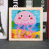 A wooden jigsaw puzzle featuring a pink, smiling jellyfish design against a colorful background.