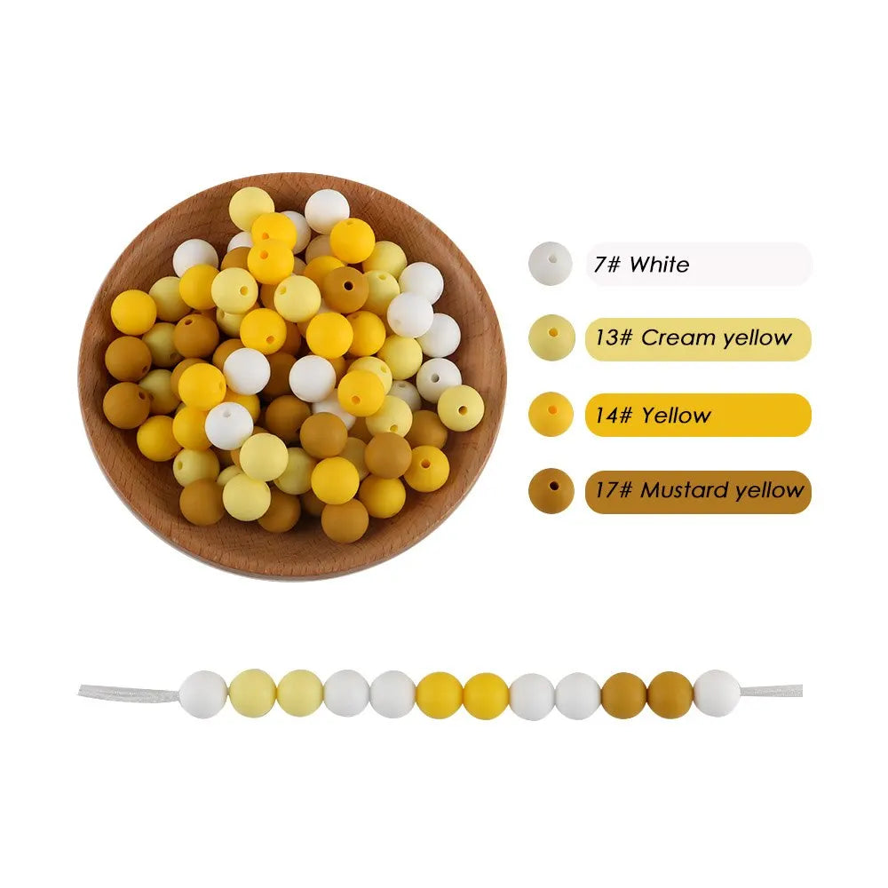 A collection of silicone round beads in various shades of yellow and white for jewelry making