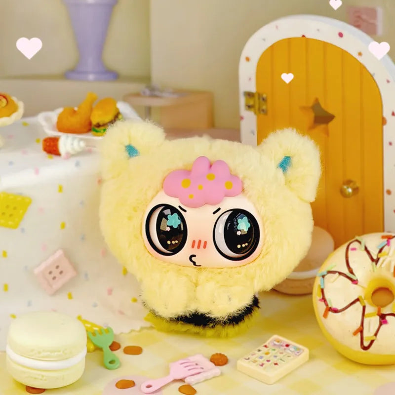 A fluffy yellow bear blind box pendant with large eyes and pink accents displayed on a light surface.