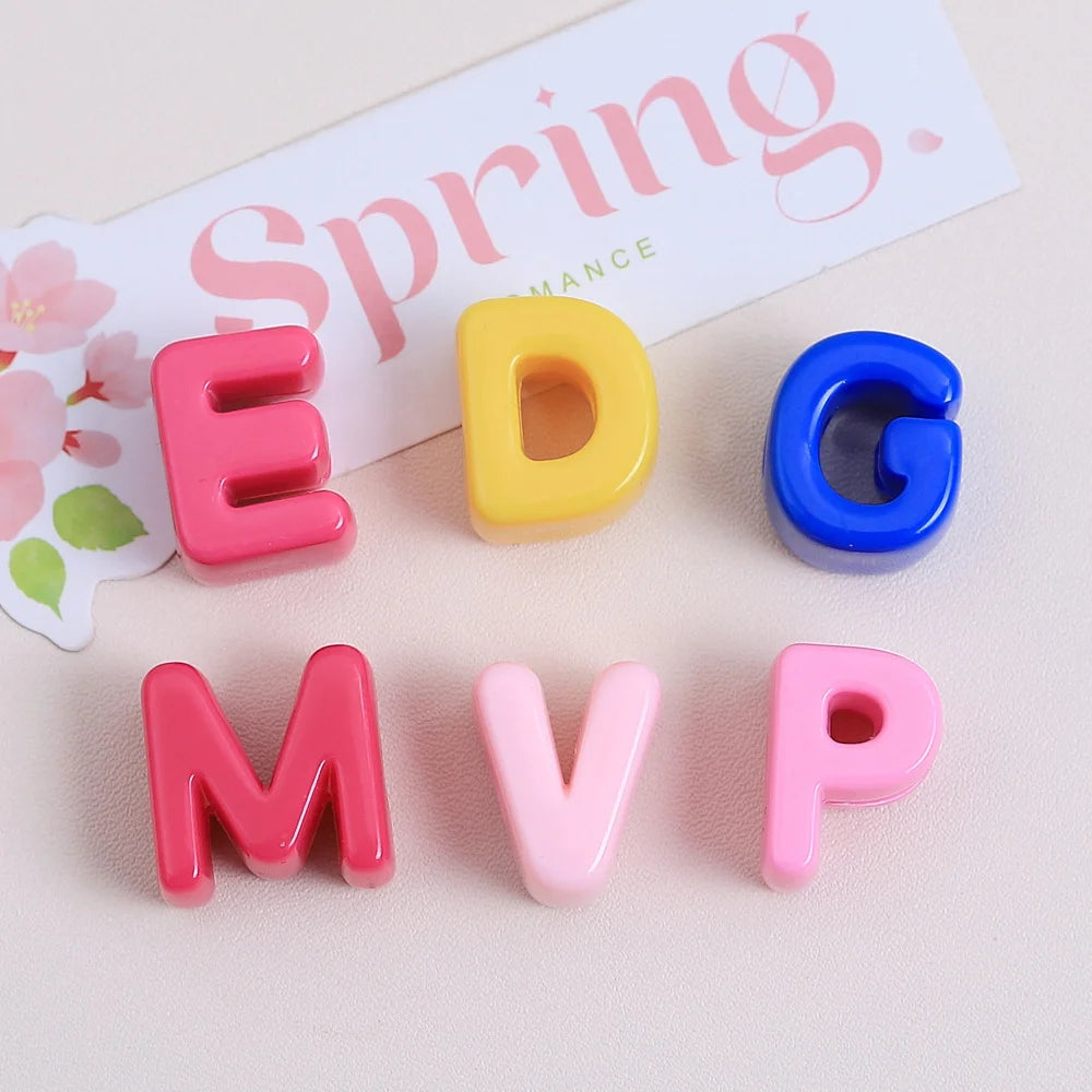 Colorful acrylic letter beads spelling EDGE and MVP arranged on a light background.
