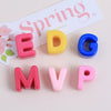 Colorful acrylic letter beads spelling EDGE and MVP arranged on a light background.