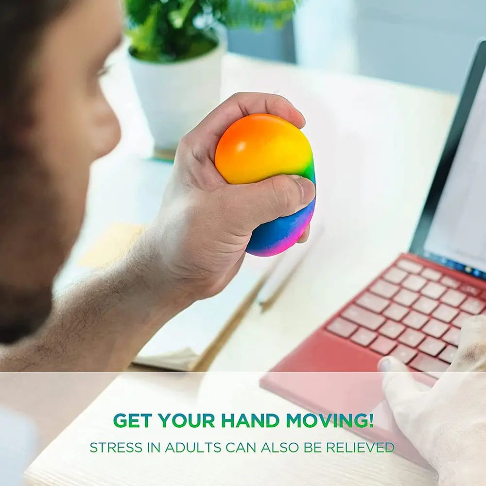 A hand holds a brightly colored, translucent stress ball with multiple colors, demonstrating a sensory fidget toy.