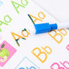 A white marker is tracing large yellow and blue letters on a colorful workbook page.